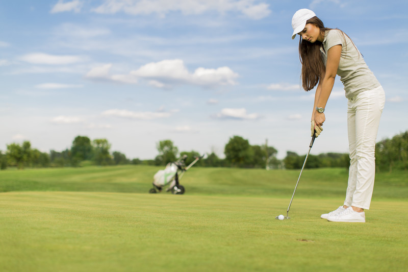 Woman golfing